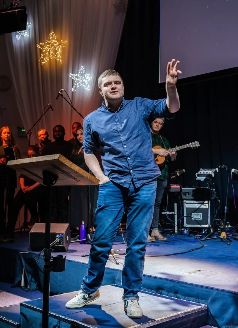 A speaker welcoming the congregation at a Christmas service