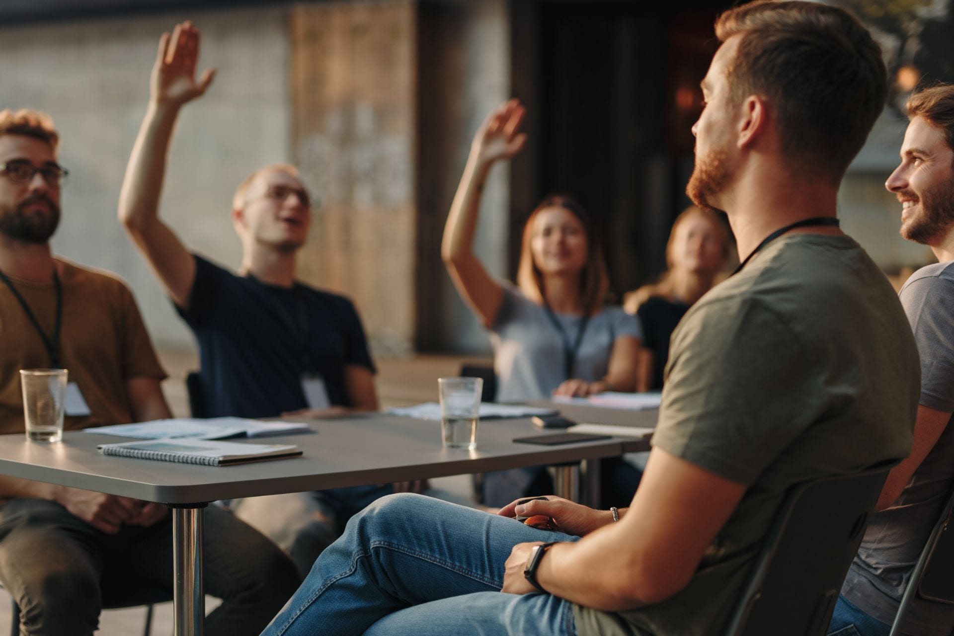 A group discussion with hands raised