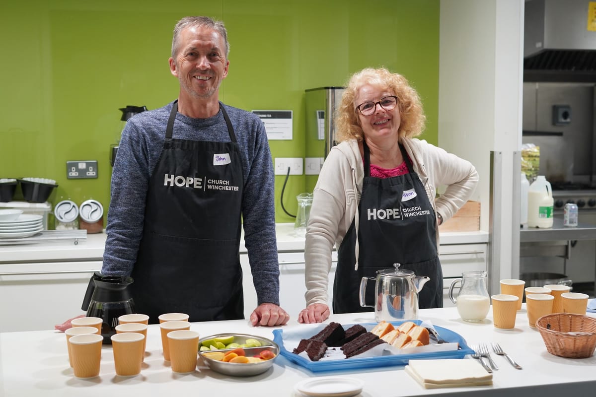 Volunteers serving tea and cake at Hope