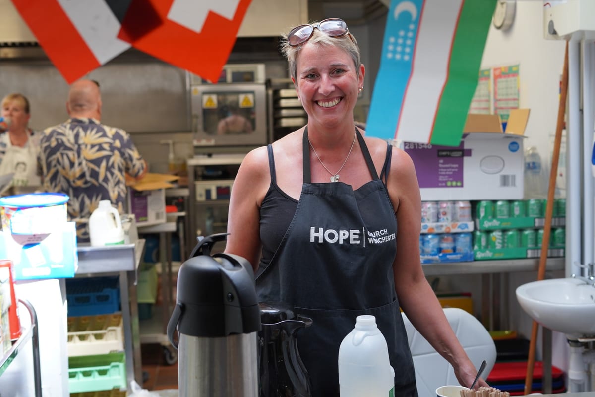 A Hope volunteer serving refreshments