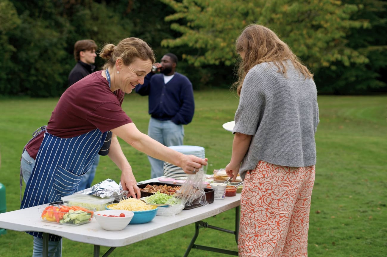 Students gathering over food together outdoors
