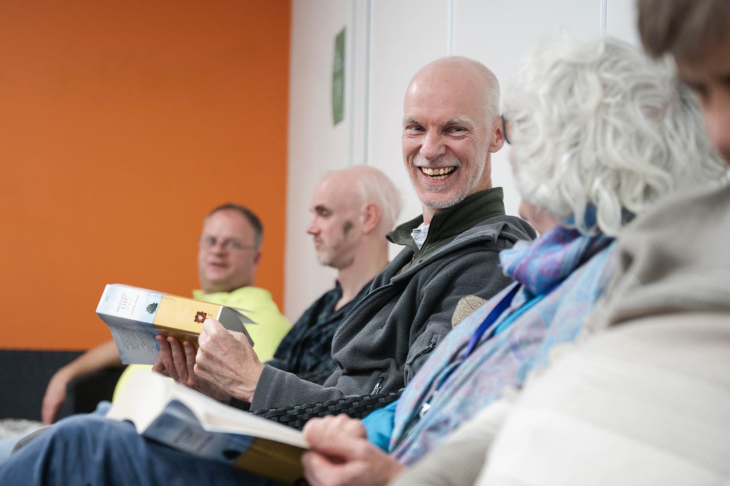 A warm welcome at Hope Church — people talking and laughing over books